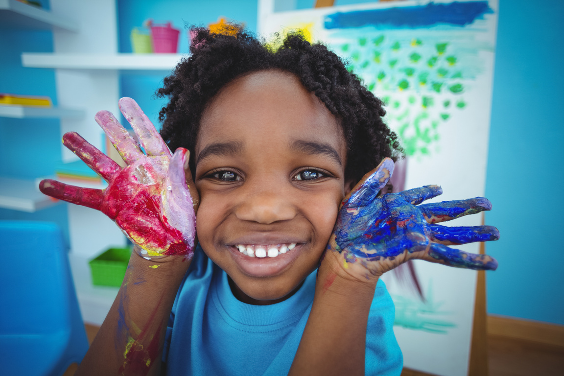 Happy kid enjoying arts and crafts painting